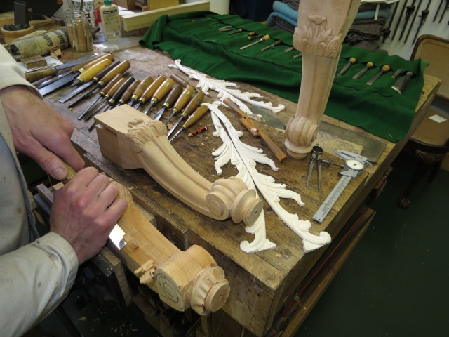 Mark carving the legs and appliqués for an original commission.