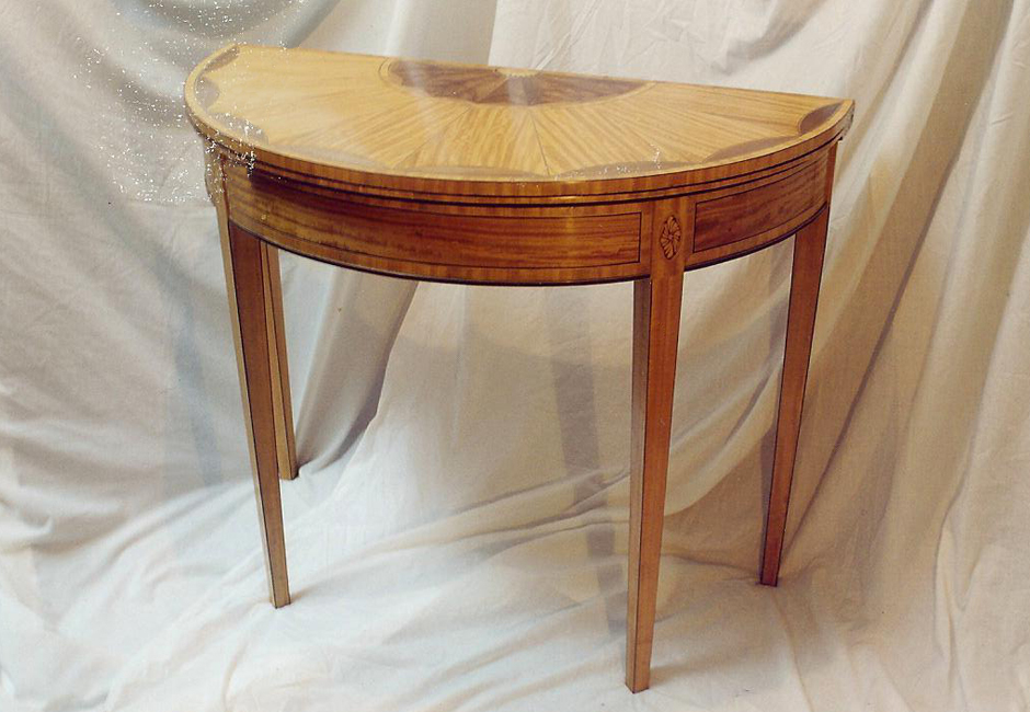 A replica of a satinwood and marquetry tea table, the original found at Kenwood House.